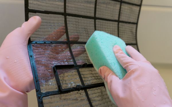 Vệ sinh lưới lọc bằng miếng mút rửa bát và dùng khăn khô để thấm khô